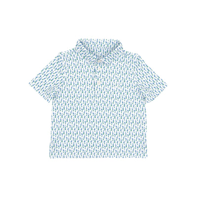 The RHOBACK Lil' Blue Bonnet 2.0 Performance Polo in White/Lake Blue features short sleeves, a collared design, all-over blue and green fish print, moisture-wicking fabric, sun protection, button-up neckline, and a relaxed fit.