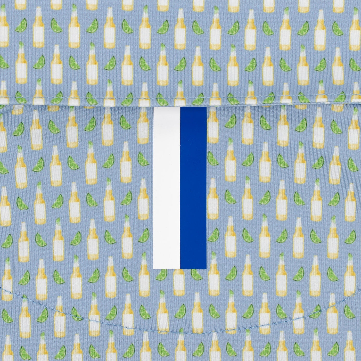 The RHOBACK The Cerveza Performance Polo in Oxford Blue features light blue, moisture-wicking fabric with a repeating beer bottle and lime pattern, plus a white and blue vertical stripe for stylish performance.