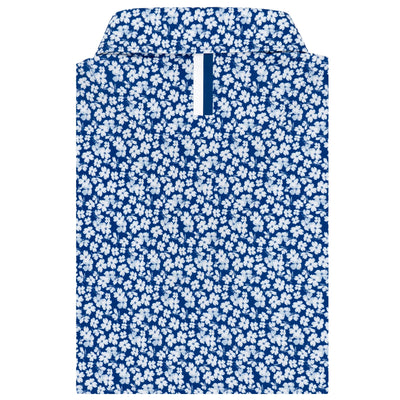 The RHOBACK Dogwood 2.0 Performance Polo in Shoal Blue/White features a dense white floral pattern, UPF sun protection, and moisture-wicking fabric. The collared shirt is neatly folded with its collar and front placket visible.