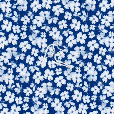 The Dogwood 2.0 Performance Polo by RHOBACK in Shoal Blue/White features a white floral pattern, moisture-wicking fabric, UPF sun protection, and a subtle white embroidered kangaroo at the center for comfort and style.