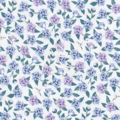 The Flutter Floral Performance Polo by RHOBACK features a white embroidered bird on moisture-wicking fabric with small purple flowers and green leaves over a pale background.