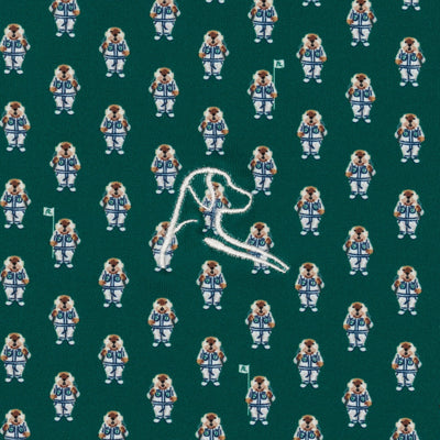 The Golfin' Gopher Performance Polo by RHOBACK features Fairway Green moisture-wicking fabric with playful gophers in white and blue, each holding flags, and a bold embroidered white "A" at the center.