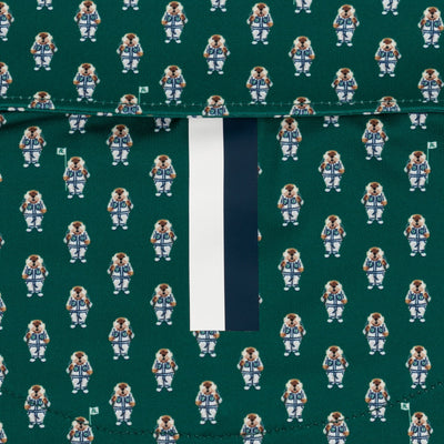 The RHOBACK "Golfin' Gopher" Performance Polo in Fairway Green/White features four-way stretch fabric with repeating small dog astronauts and a vertical dark green and white stripe near the center.
