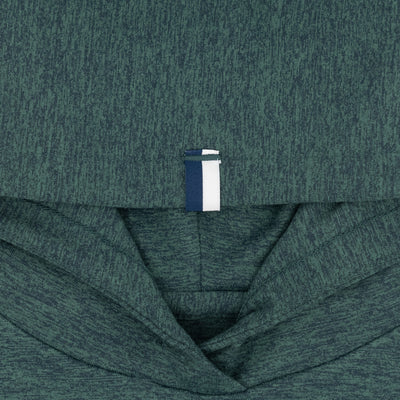 Close-up of the RHOBACK Lil' Hesi Performance Hoodie in Heather - Ponderosa Green/Willow Green, featuring VSoft™ fabric and a white and navy blue pull tab at the neckline, with the hood and folded upper section visible.