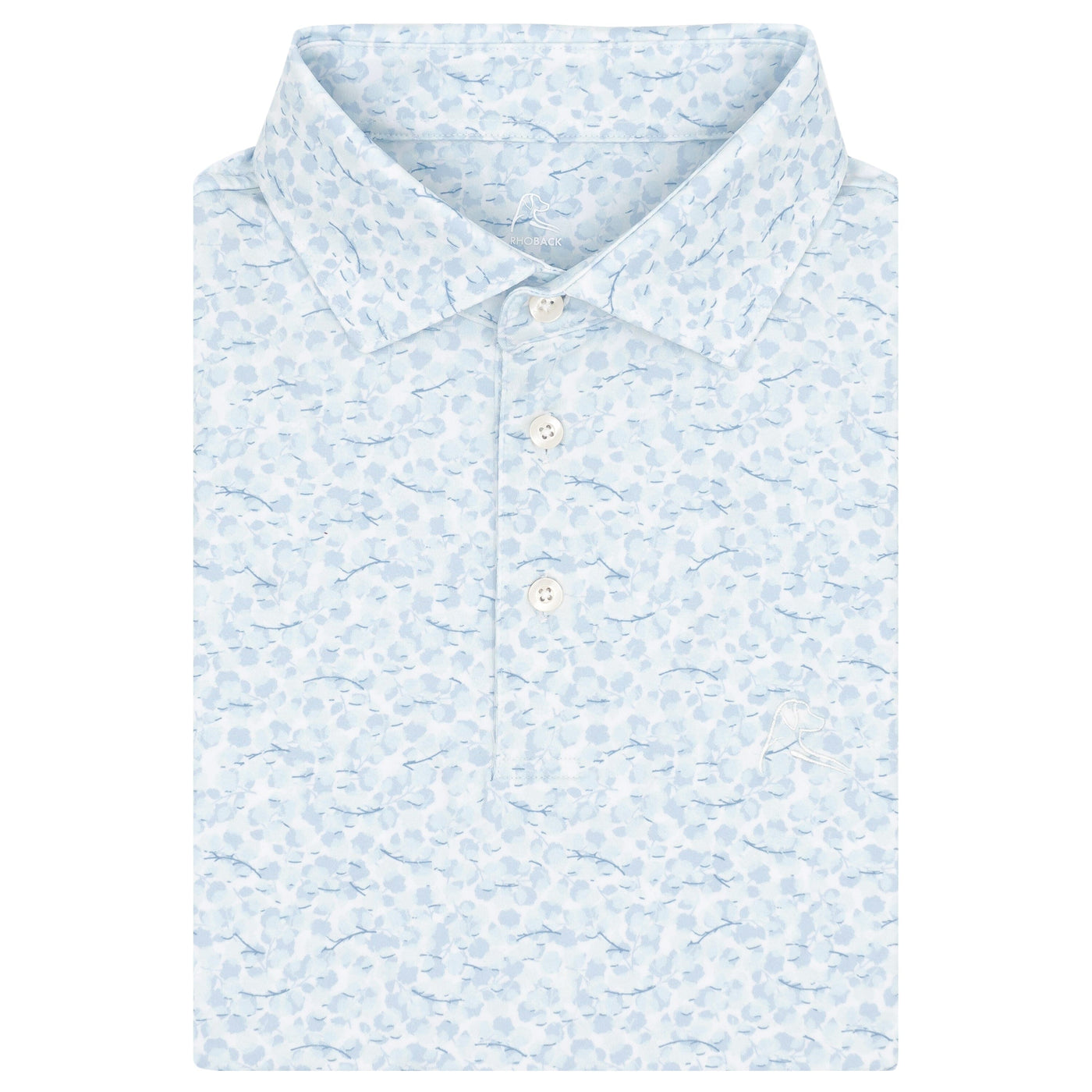 The RHOBACK Iridescence Performance Polo in White/Pure Blue features an abstract, cloud-like pattern, breathable moisture-wicking fabric, a folded collar, and three white buttons. The men’s shirt is neatly folded on a white background.