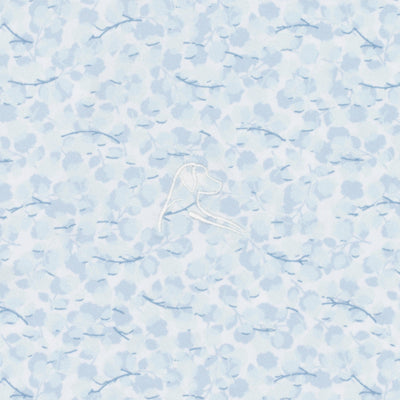 The RHOBACK Iridescence Performance Polo in White/Pure Blue features light blue patterned fabric with abstract shapes and small branches, plus a subtle white embroidered dog's head and breathable, moisture-wicking comfort.