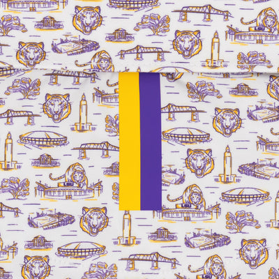 The RHOBACK LSU Baton Rouge | Collegiate Polo - White/Reauxback Purple features white performance fabric with purple and gold tiger heads, buildings, bridges, and bold central gold and purple stripes for a spirited LSU look.
