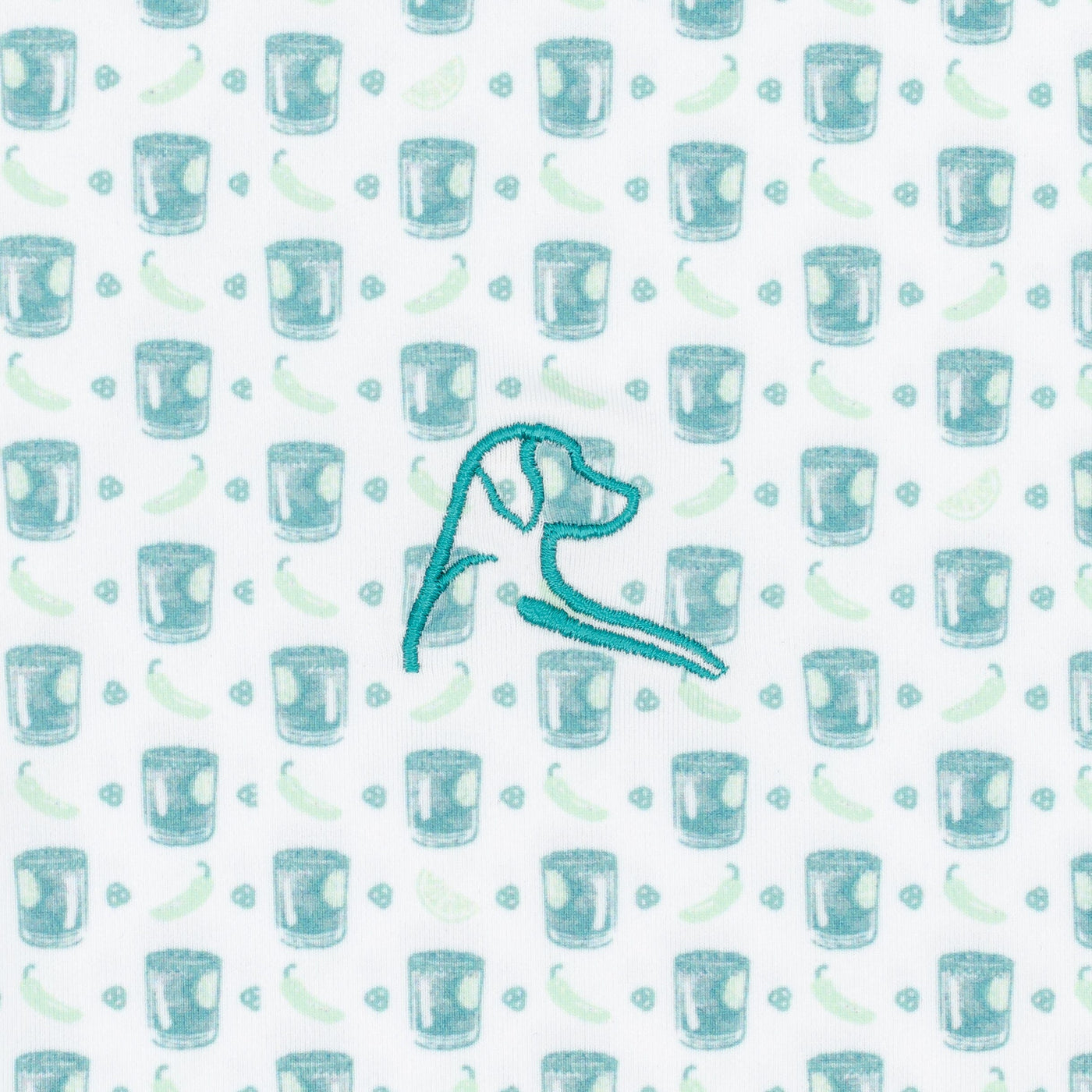 The Spicy Marg Performance Polo by RHOBACK features a breathable white and robin's egg fabric patterned with cocktail glasses, lime wedges, chili peppers, and a teal-embroidered dog’s head—perfect for a unique style.