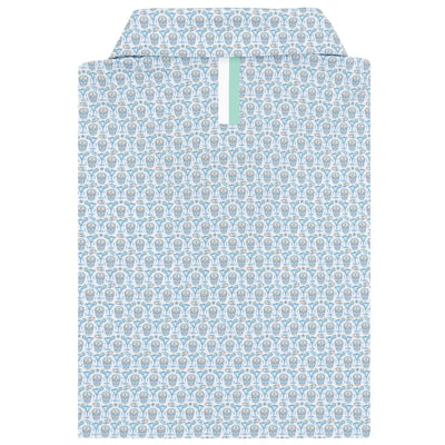 The Sugar Skull Performance Polo by RHOBACK in white/maritime blue has an abstract circular pattern and a mint green accent stripe inside the collar, all crafted from moisture-wicking fabric for enhanced comfort.